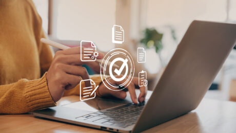 Hand of young woman holding a pen pointing to document and mark correct sign for standard quality control certification assurance concept.